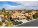 Aerial view showcases this property's three-car garage, landscaped front yard, and well-maintained tile roof at 8816 Saint Pierre Dr, Las Vegas, NV 89134