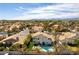 Aerial view of a backyard featuring a pool and lounge area, artificial grass, and a home's architecture at 8816 Saint Pierre Dr, Las Vegas, NV 89134