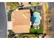 Aerial view of backyard with a sparkling pool, spa, and outdoor seating surrounded by green turf and manicured landscaping at 8816 Saint Pierre Dr, Las Vegas, NV 89134
