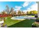 Great backyard featuring a pool, lounge furniture, modern fence, and green artificial grass at 8816 Saint Pierre Dr, Las Vegas, NV 89134