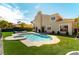 Exterior backyard view of a pool, lounge furniture, artificial grass, and home's facade at 8816 Saint Pierre Dr, Las Vegas, NV 89134