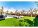 This backyard offers a pool, seating area, lush artificial turf, and stylish horizontal plank fencing at 8816 Saint Pierre Dr, Las Vegas, NV 89134