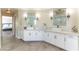 Elegant bathroom boasting double sinks, white cabinetry, and modern fixtures at 8816 Saint Pierre Dr, Las Vegas, NV 89134
