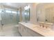 Modern bathroom featuring double sinks, sleek countertops, and a glass-enclosed shower at 8816 Saint Pierre Dr, Las Vegas, NV 89134