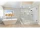 Bright bathroom with a soaking tub and a glass-enclosed shower at 8816 Saint Pierre Dr, Las Vegas, NV 89134