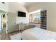 Cozy bedroom with window seat, built-in shelving, and TV at 8816 Saint Pierre Dr, Las Vegas, NV 89134