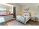 Bright bedroom featuring a window seat, built-in bookshelves, and a comfortable bed at 8816 Saint Pierre Dr, Las Vegas, NV 89134