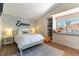 Bright bedroom with floral wallpaper, a built-in window seat, and modern furnishings at 8816 Saint Pierre Dr, Las Vegas, NV 89134