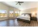 Spacious bedroom featuring large windows, hardwood floors, and a comfortable king-sized bed at 8816 Saint Pierre Dr, Las Vegas, NV 89134