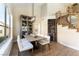 Bright dining area features modern lighting, display cabinet and nearby staircase at 8816 Saint Pierre Dr, Las Vegas, NV 89134