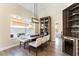 Bright dining room with display cabinet, wine fridge, and large windows at 8816 Saint Pierre Dr, Las Vegas, NV 89134