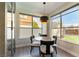 Bright dining area with large windows, wood floors, and modern light fixtures at 8816 Saint Pierre Dr, Las Vegas, NV 89134
