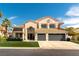 Two-story home featuring a three-car garage, tiled roof, and well-manicured lawn at 8816 Saint Pierre Dr, Las Vegas, NV 89134