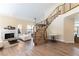 Bright living room features a fireplace, staircase, and wood-look flooring at 8816 Saint Pierre Dr, Las Vegas, NV 89134