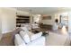 Open living room with built-in shelving, modern furniture, and a view to the kitchen at 8816 Saint Pierre Dr, Las Vegas, NV 89134