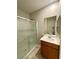 Bathroom with glass-enclosed shower, sleek vanity, and large mirror at 9136 Cocowoods Pl, Las Vegas, NV 89148