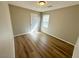 Bright bedroom with wood-look flooring and a window at 9136 Cocowoods Pl, Las Vegas, NV 89148