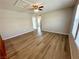 Spacious bedroom with wood flooring, natural light, and modern ceiling fan at 9136 Cocowoods Pl, Las Vegas, NV 89148