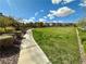 Well-manicured community greenspace with walking path and lush landscaping at 9136 Cocowoods Pl, Las Vegas, NV 89148