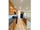 Modern kitchen with granite countertops, stainless steel appliances, and sleek wooden cabinetry at 9136 Cocowoods Pl, Las Vegas, NV 89148