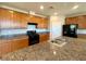 Kitchen with granite countertops, stainless steel appliances, and island with a sink at 9136 Cocowoods Pl, Las Vegas, NV 89148