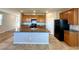 Open concept kitchen with granite countertops, stainless steel appliances, and spacious island at 9136 Cocowoods Pl, Las Vegas, NV 89148