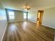 Large living room with fan and wood-look laminate flooring at 9136 Cocowoods Pl, Las Vegas, NV 89148