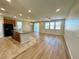 Expansive living area featuring wood floors, recessed lighting, and granite island at 9136 Cocowoods Pl, Las Vegas, NV 89148