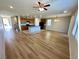 Open-concept living area with wood flooring, granite island, and updated appliances at 9136 Cocowoods Pl, Las Vegas, NV 89148