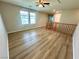 Upstairs loft area with new wood flooring, natural light, and ceiling fan at 9136 Cocowoods Pl, Las Vegas, NV 89148