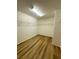 Walk-in closet featuring laminate flooring and white walls at 9136 Cocowoods Pl, Las Vegas, NV 89148