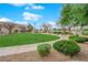 Well-maintained common area with lush green grass, trees, bushes and a sidewalk at 9315 Indian Corn Ct # 101, Las Vegas, NV 89178
