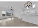 Bright living room with light wood-look floors, ceiling fan, and eat-in kitchen at 9315 Indian Corn Ct # 101, Las Vegas, NV 89178