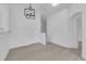Living room area with light wood-look floors and modern chandelier at 9315 Indian Corn Ct # 101, Las Vegas, NV 89178