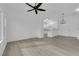 Open-concept living room with light wood-look flooring flows into kitchen area at 9315 Indian Corn Ct # 101, Las Vegas, NV 89178