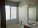 Bright bathroom with a shower-tub combination and a large window for natural light at 9436 Silvaner Ct, Las Vegas, NV 89123