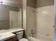 Well-lit bathroom features a tiled shower-tub combo, white sink, and a large mirror at 9436 Silvaner Ct, Las Vegas, NV 89123