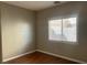 Comfortable bedroom featuring neutral walls, hardwood floors, and a window providing natural light at 9436 Silvaner Ct, Las Vegas, NV 89123