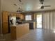 Spacious kitchen with stainless steel appliances, wooden cabinets, and a center island with backyard access at 9436 Silvaner Ct, Las Vegas, NV 89123