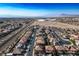High aerial view of a neighborhood displaying rows of houses, streets, and a distant horizon at 948 Mill Run Creek Ave, Henderson, NV 89002