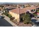 Aerial shot showcasing a spacious home with a tile roof, lush landscaping, and a private backyard in a residential neighborhood at 948 Mill Run Creek Ave, Henderson, NV 89002