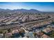 Panoramic aerial view of a residential community, showcasing diverse homes, winding roads, and a scenic mountain backdrop at 948 Mill Run Creek Ave, Henderson, NV 89002