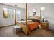 Bright main bedroom featuring a wooden canopy bed and ample natural light at 948 Mill Run Creek Ave, Henderson, NV 89002