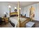 Elegant main bedroom features a canopy bed and an ensuite bathroom at 948 Mill Run Creek Ave, Henderson, NV 89002