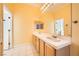 Bright bathroom with double sink vanity and tile flooring at 9733 Camden Hills Ave, Las Vegas, NV 89145