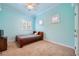 Bedroom with bright paint, shuttered windows, and a ceiling fan at 9733 Camden Hills Ave, Las Vegas, NV 89145