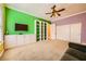Spacious room with built-in shelves, storage cabinets, and a ceiling fan at 9733 Camden Hills Ave, Las Vegas, NV 89145