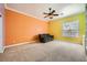 Colorful bedroom featuring a comfortable couch, ceiling fan, and ample natural light from the window at 9733 Camden Hills Ave, Las Vegas, NV 89145