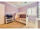 Bedroom featuring a bunk bed, a dresser, and shuttered windows at 9733 Camden Hills Ave, Las Vegas, NV 89145