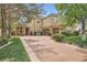 Charming two-story home featuring a brick-accented entrance, mature trees, and a well-manicured lawn at 9733 Camden Hills Ave, Las Vegas, NV 89145